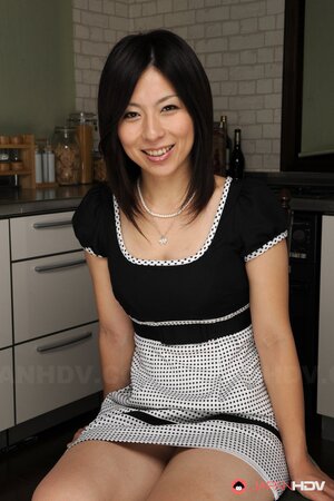 Randy brunette Asian bares breasts but man comes feeling them up inn kitchen