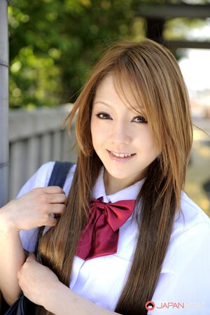 Oriental MILF Ria Sakurai squats wearing a very short skirt and flashing panties