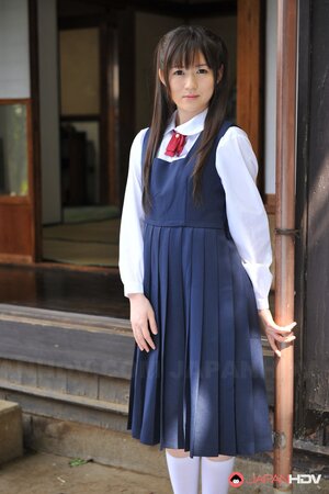 Innocent Japanese schoolgirl with beautiful eyes walks seductively under sun