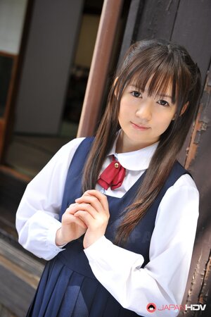 Innocent Japanese schoolgirl with beautiful eyes walks seductively under sun