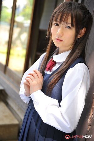 Innocent Japanese schoolgirl with beautiful eyes walks seductively under sun