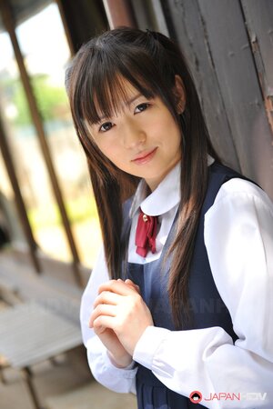Innocent Japanese schoolgirl with beautiful eyes walks seductively under sun