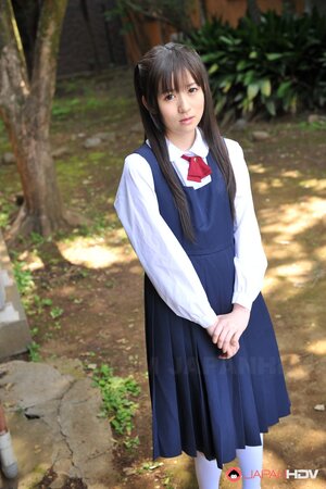 Innocent Japanese schoolgirl with beautiful eyes walks seductively under sun