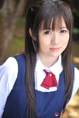 Innocent Japanese schoolgirl with beautiful eyes walks seductively under sun