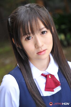 Innocent Japanese schoolgirl with beautiful eyes walks seductively under sun