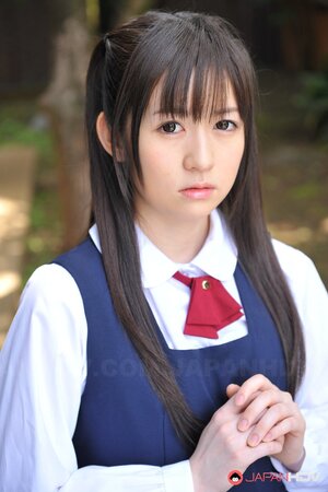 Innocent Japanese schoolgirl with beautiful eyes walks seductively under sun