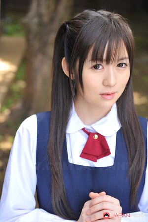 Innocent Japanese schoolgirl with beautiful eyes walks seductively under sun