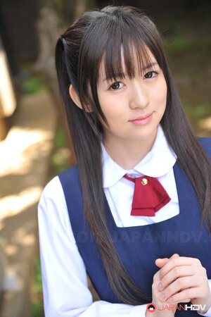 Innocent Japanese schoolgirl with beautiful eyes walks seductively under sun