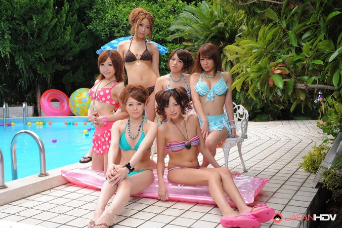 Oriental girlfriends in skimpy bikinis rest half-naked with men poolside