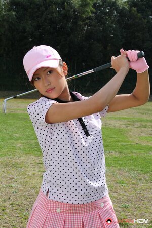 Oriental golf girl wears shirt and skirt but dislikes panties and flashes muff