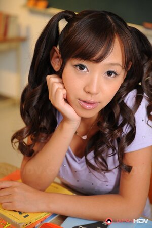 Cheerful Japanese coed with pigtails is shy about showing tits and pussy