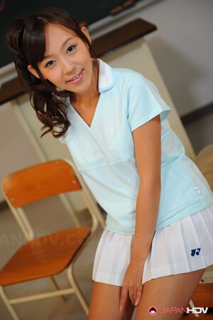 Cheerful Japanese coed with pigtails is shy about showing tits and pussy