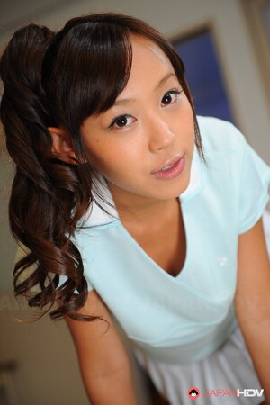 Cheerful Japanese coed with pigtails is shy about showing tits and pussy