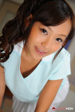 Cheerful Japanese coed with pigtails is shy about showing tits and pussy
