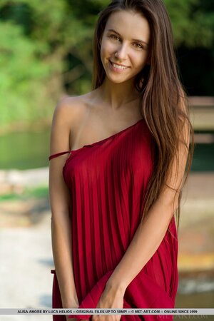 Alisa Amore disrobes to pose naked near a dam