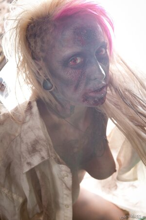 Horny zombie with big tits tears off her clothes in fetish pics