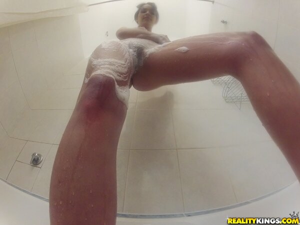 Innocent sexpot with perfect boobs seductively washes sexy body in bathroom