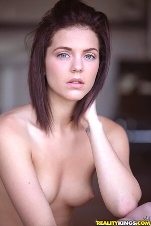 Thoughtful teen Kiera Winters takes off white sweaters and panties on the balcony