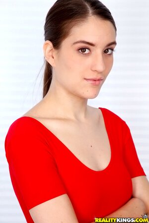 Cutie with ponytail takes off jeans and red top to impress guys with body