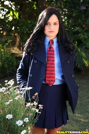 Captivating brunette college girl spreads legs in garden after classes