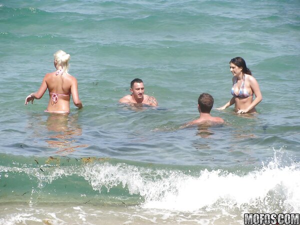 Seductive girls in bikinis like to spend good time and pose on the beach