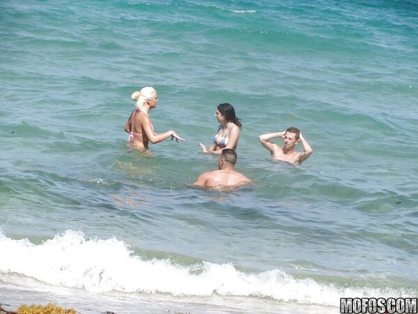 Seductive girls in bikinis like to spend good time and pose on the beach
