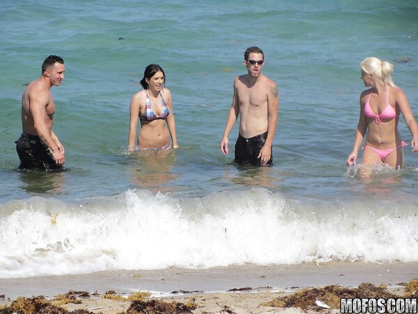 Seductive girls in bikinis like to spend good time and pose on the beach