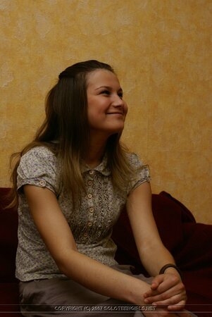 Adorable newcomer quickly undresses and relaxes completely naked on red couch