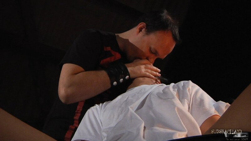 Dominant man lights a candle and pours girl's slender body with hot wax