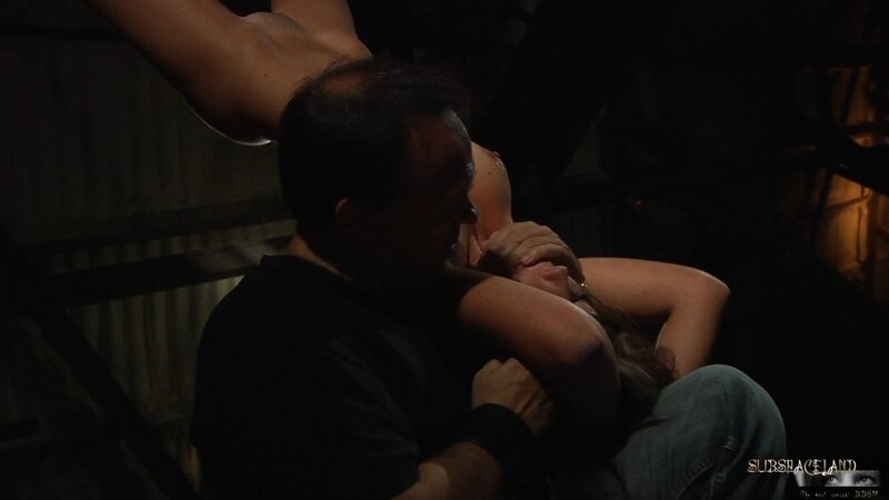 Chick gets her first BDSM sex lesson being punished by man in black in dark cellar