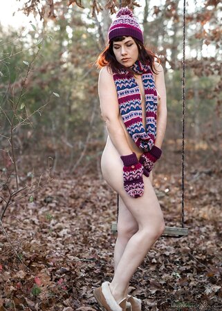 Female is alone on the swing and ignoring the weather she gets naked