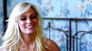 Blonde pulls on a dick on the bed while she is with her man
