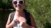 A lovely woman is getting naked in the forest to make love