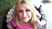 A blonde that has a lust filled face is sucking close to the camera