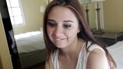 A sweet babe with a sexy face is riding a big pecker on the bed
