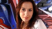 A brunette is doing a threesome and is giving a double blow job