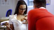 A slut is shaking her tight ass for her friend in the classroom