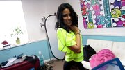A Latina with an infectious smile is sucking a very large pole