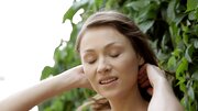 A kinky redhead is getting naked in the garden to jack off