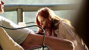 A redhead with perky tits is getting her lips around a big dick