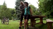A brunette with pigtails is getting naked in the garden to fuck