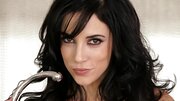 A raven haired girl is parading her body in an alluring way