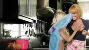 A blonde with nice big fake tits is with a hot teen, touching her