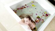 Scarlett Sage satisfies pussy in the bathtub with flowers