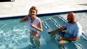 Tiny blonde facialized after sex with ball bruiser by the pool