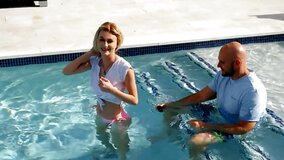 Tiny blonde facialized after sex with ball bruiser by the pool