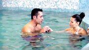 Elegant brunette has foreplay in the pool before sex