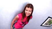 Foxy girl talks dirty while fingering her butt on the couch