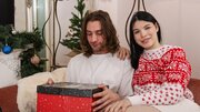 Long-haired lad and a pale brunette celebrating together